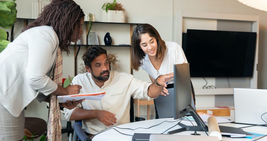 Professionals collaborating around a table with 'Significance of PR' on a presentation screen